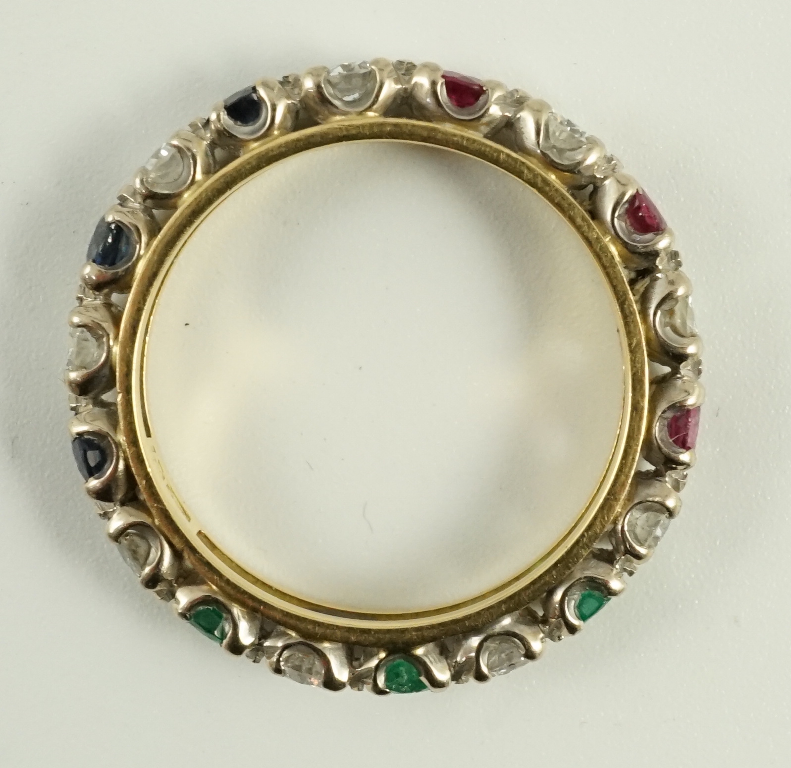 A modern 18ct gold, ruby, sapphire, emerald and diamond set full eternity ring